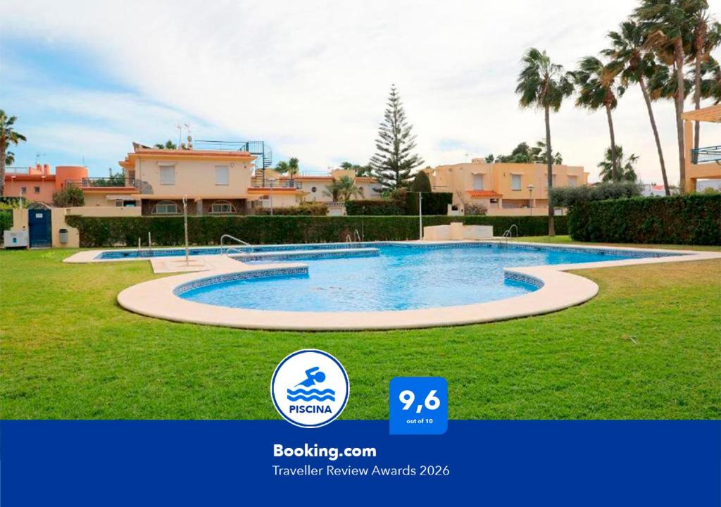 a picture of a swimming pool in front of some houses at Apartalux Vera Palace in Vera