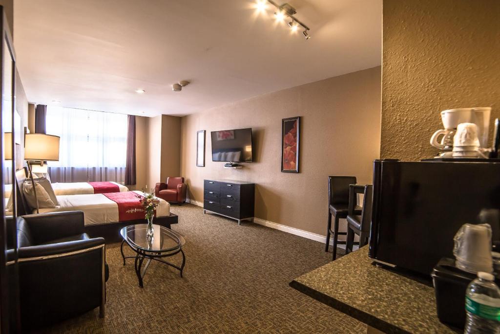 a hotel room with a bed and a living room at Century Casino & Hotel Cripple Creek in Cripple Creek