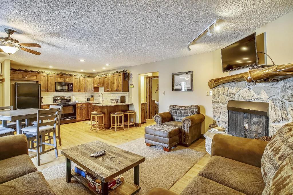 a living room with a couch and a fireplace at Tannhauser 222 in Breckenridge