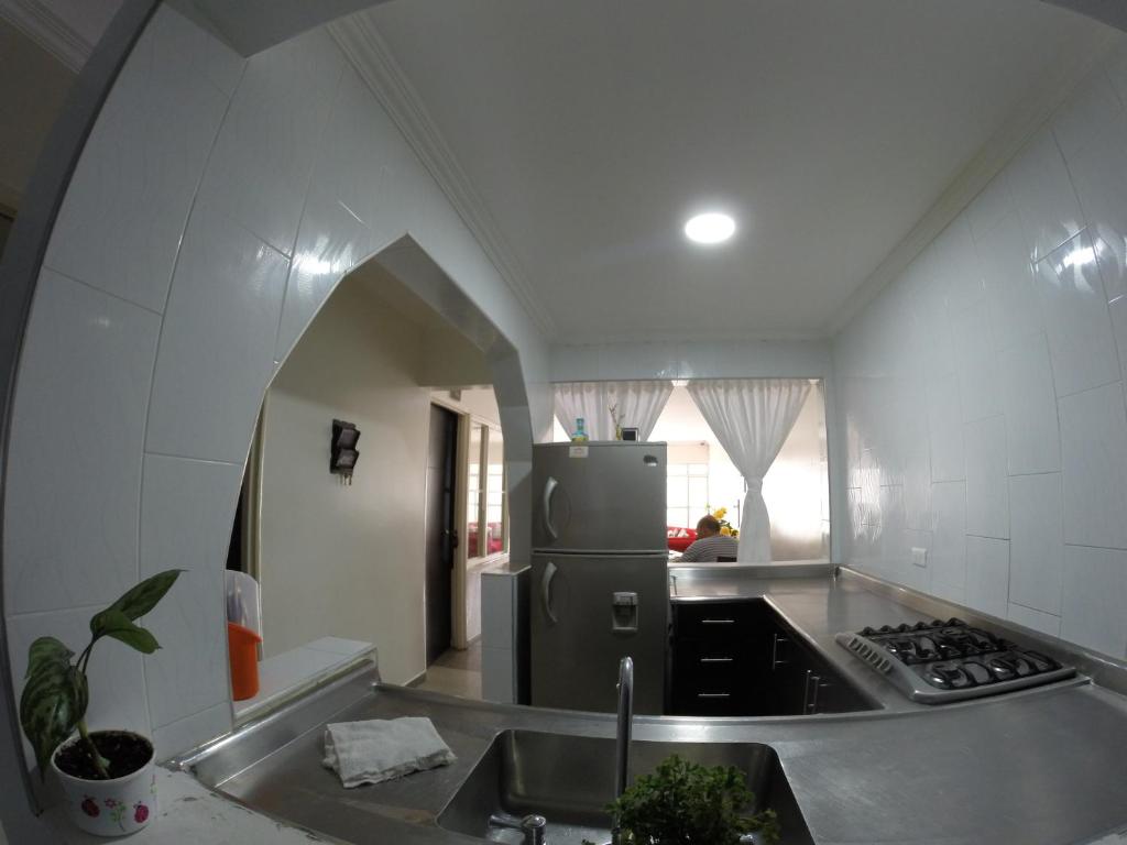 a kitchen with a sink and a refrigerator at Casa Villavicencio in Villavicencio