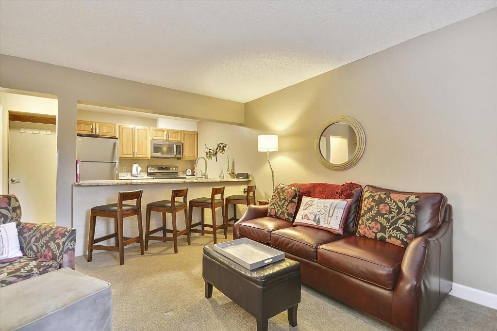 a living room with a couch and a kitchen at Tannhauser 225 in Breckenridge