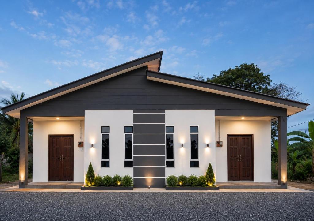 a house with a black and white facade at Dmana Homestay Arau Perlis in Arau