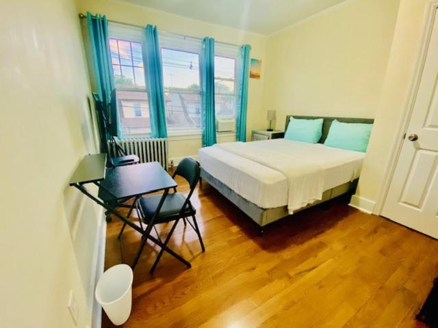a bedroom with a bed and a table and a chair at CaneView Properties - 3 in Irvington