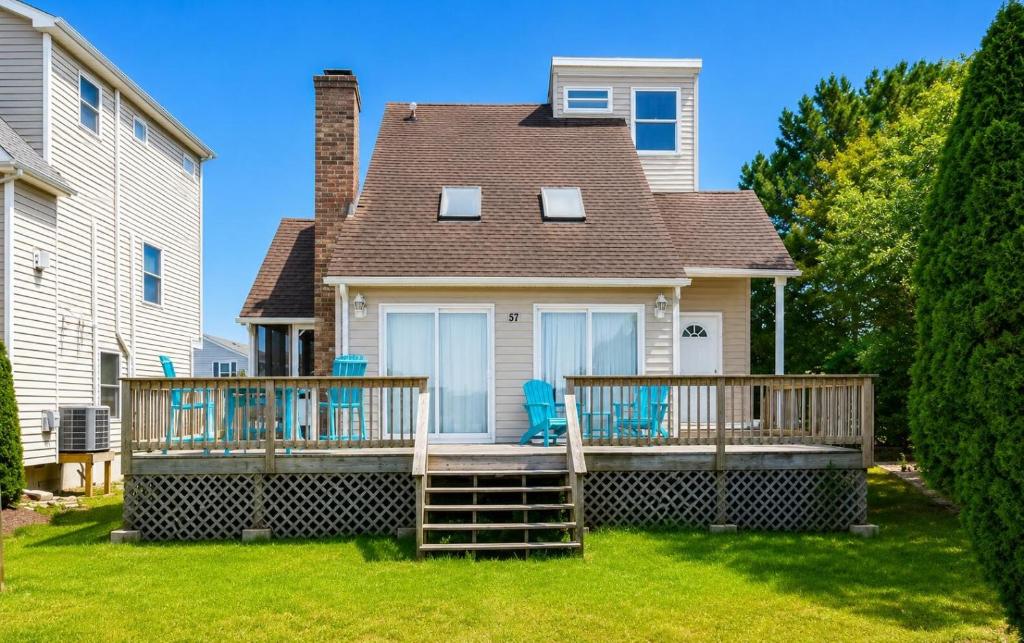a house with a deck with blue chairs on it at Ocean Pines-Harborview Drive 17 home in Ocean Pines