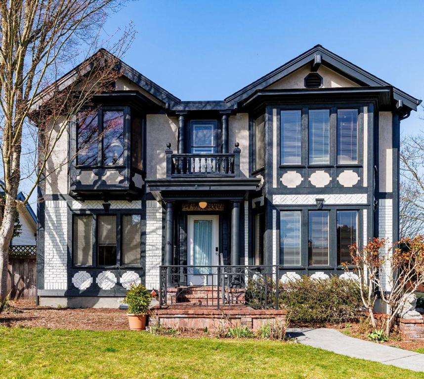 a large black and white house with at Spacious Proctor Tudor-Sleeps 16-Dog Friendly-Walk in Tacoma