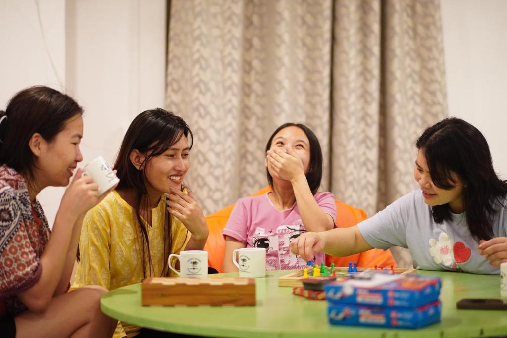 a group of women sitting around a table playing a game at Wanderpals Guwahati in Guwahati