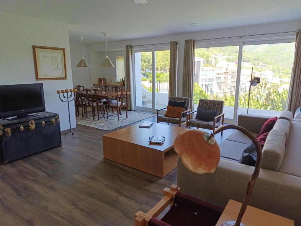 a living room with a couch and a table at Casa do Patrão Serradalto in Manteigas