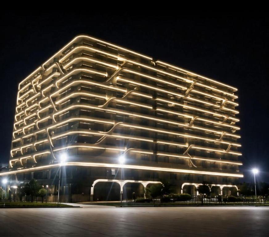 a large building lit up at night at Appart Ilyani in El Kseur