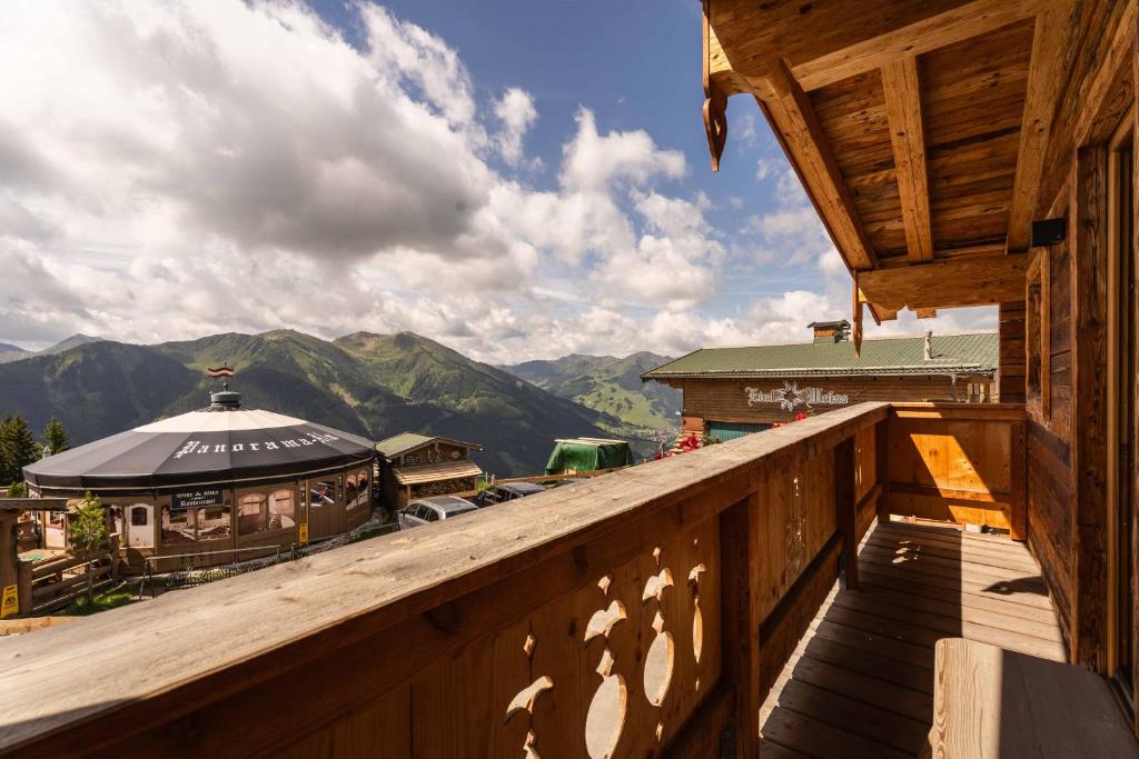 a wooden balcony with a view of a mountain at Panorama Alm Chalets by we rent JOKERCARD INCLUDED in Saalbach-Hinterglemm