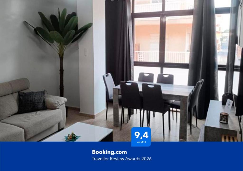 a living room with a table and chairs and a couch at Apartalux San Pedro Sol in San Pedro del Pinatar
