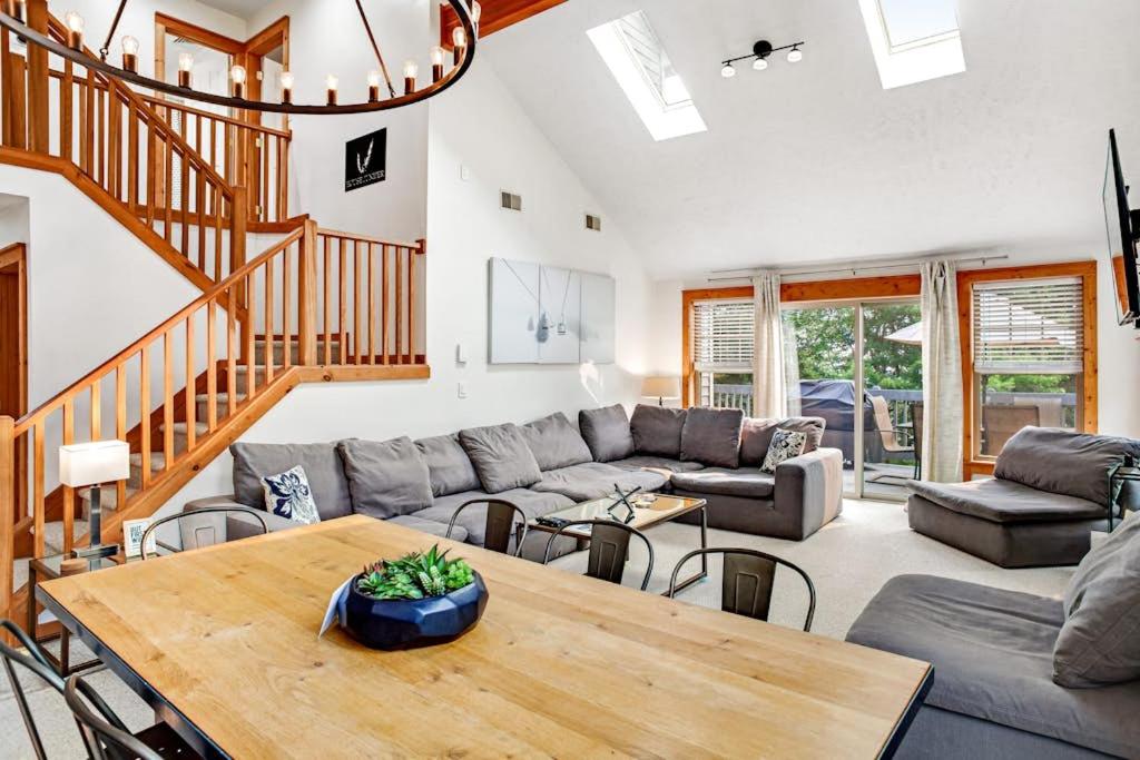 a living room with a couch and a table at House Juniper in Tannersville