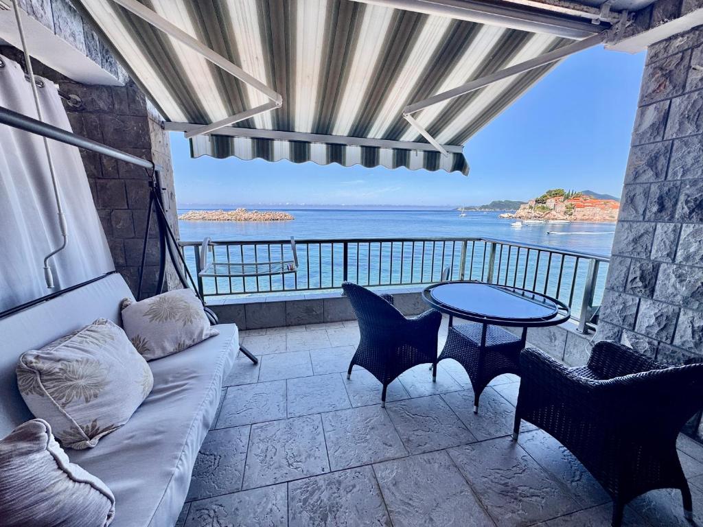 a living room with a couch and a table at Apartments Lungo Mare in Sveti Stefan