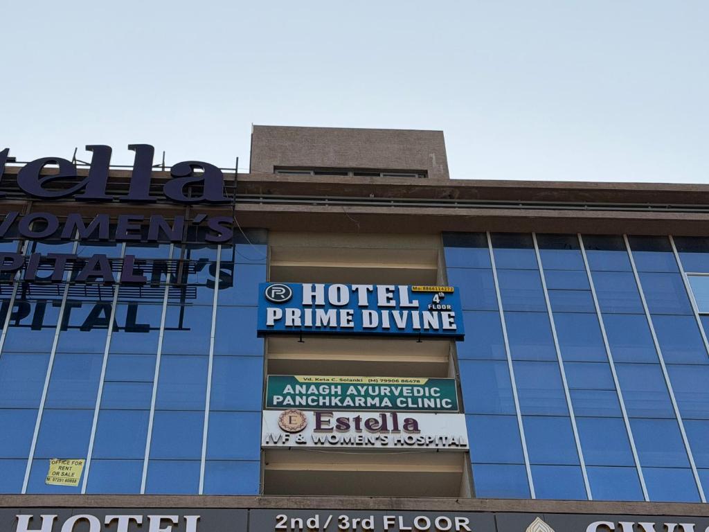 a building with signs on the side of it at Hotel Prime Divine in Ahmedabad