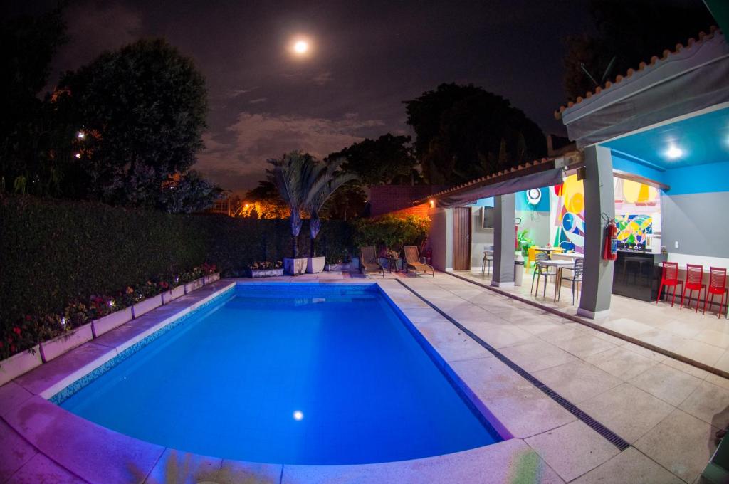 a swimming pool in a backyard at night at Icaraí Bed & Breakfast in Niterói