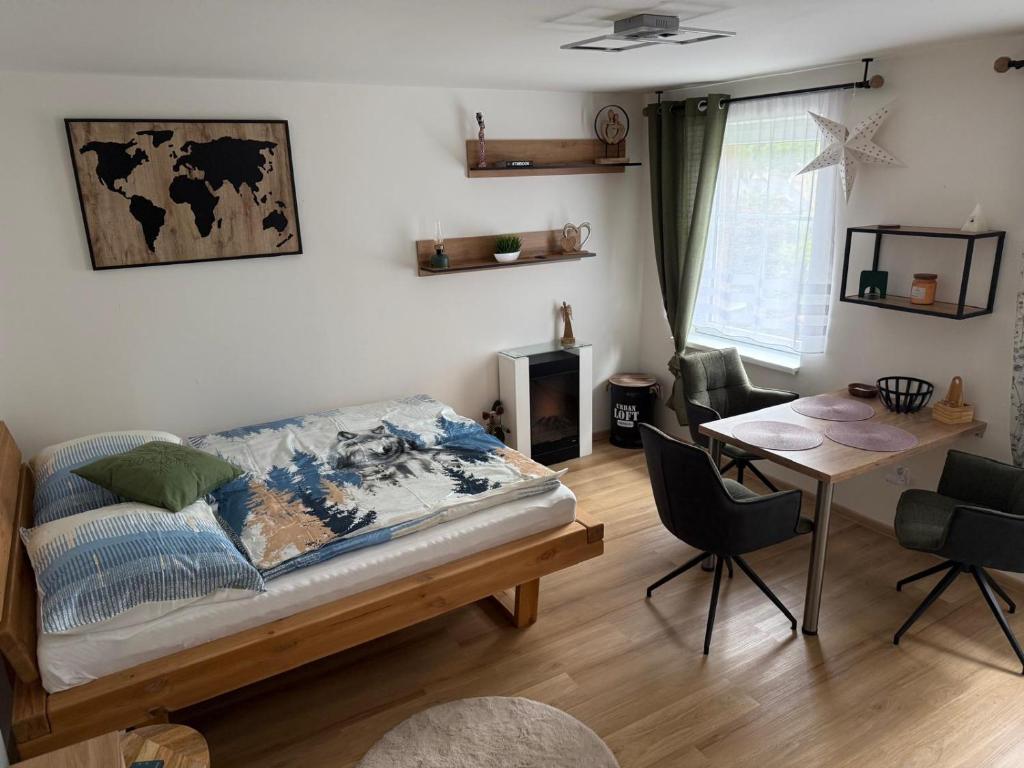 a bedroom with a bed and a desk and a table at Apartment WOLF in Kořenov