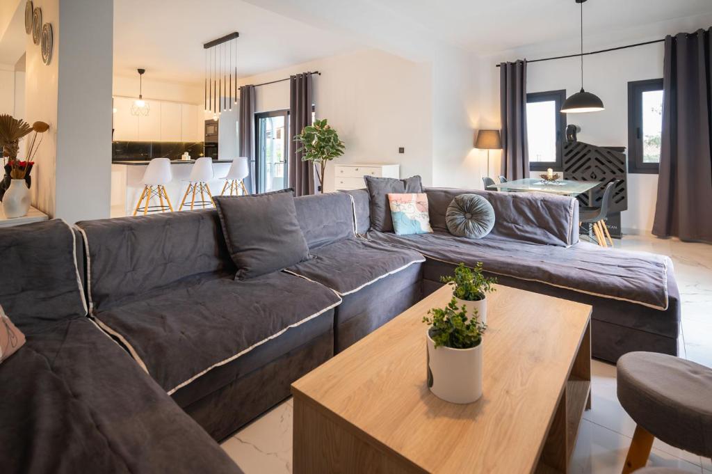 a living room with a blue couch and a table at Divodi View in Mytikas