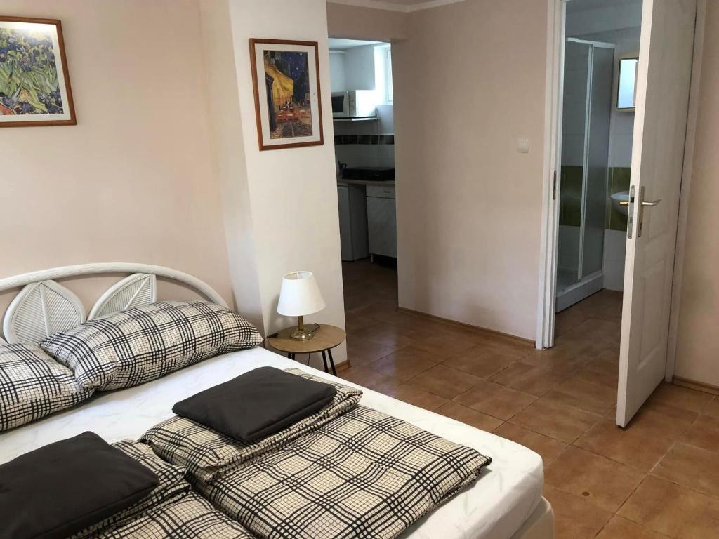a bedroom with a bed with pillows on it at Pärlan 2 in Balatonboglár