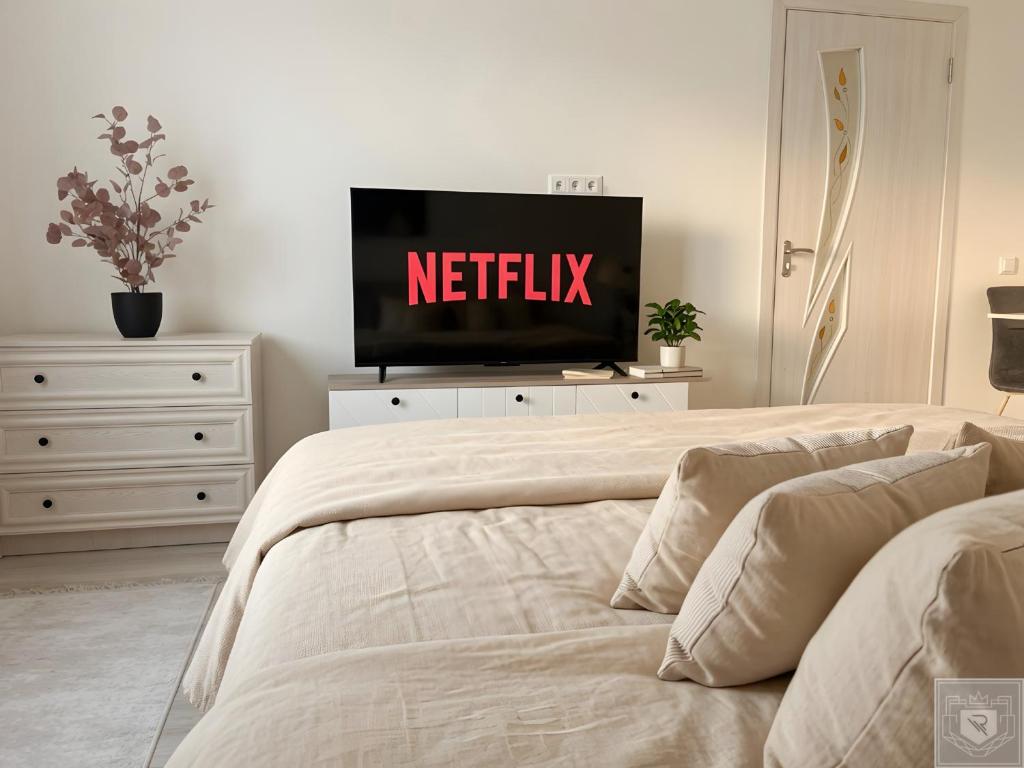 a bedroom with a bed with a netflix sign on it at RentHouse Apartments Cozy Stay in Chişinău