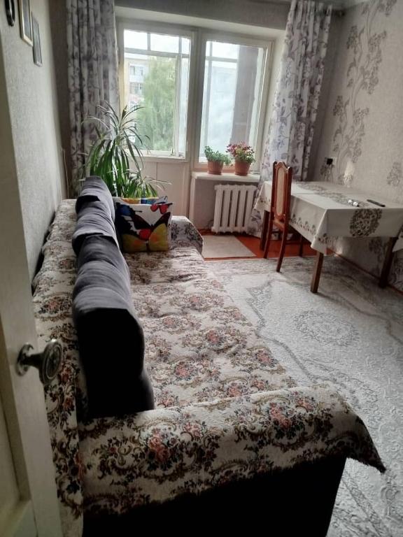 a living room with a couch and a window at Beka guest house in Karakol