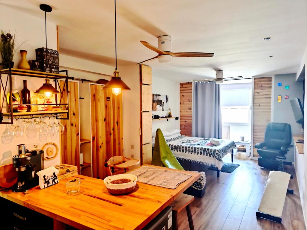 a living room with a table and a bedroom at Loft PLAYA -60m- & TRABAJO -online- in Almería
