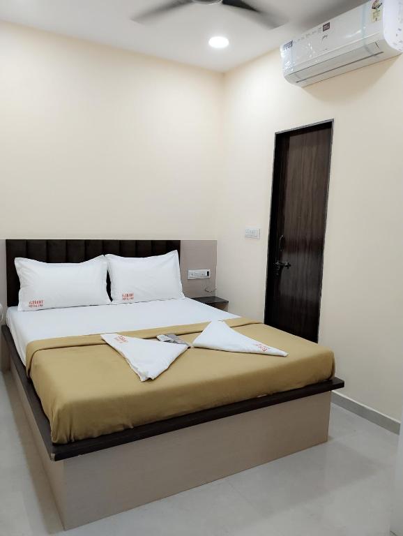 a bedroom with a large bed in a room at Elegant Inn Hotel in Surat