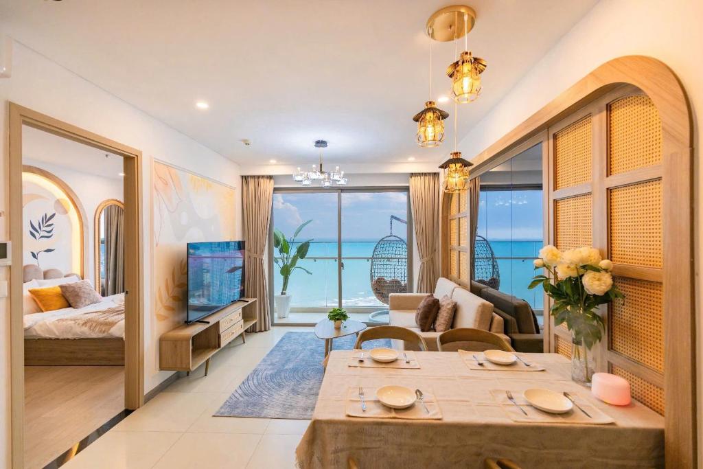 a living room with a bed and a couch and a table at The Song Apartment Vung Tau - Căn Hộ Du Lịch 5 Sao Cạnh Biển Vũng Tàu in Vung Tau