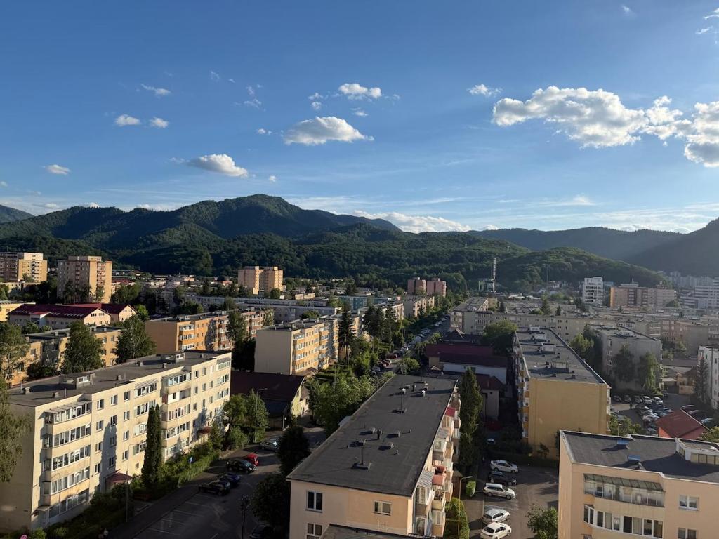 an aerial view of a city with mountains in the background at Cu Tâmpa la fereastră - Spacious Apartment with Mountain View & 2 Free Parking Spaces in Braşov