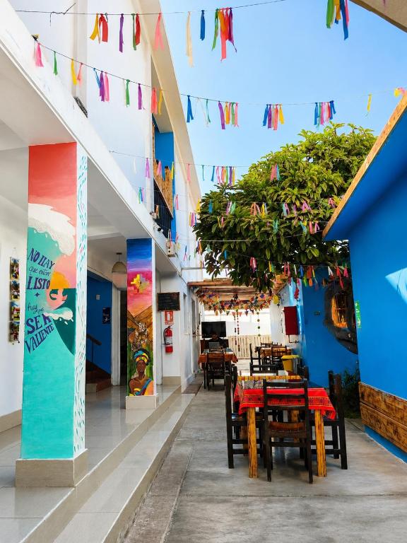 a dining area with tables and chairs and flags at Hotel Illariy Wasi in Arica