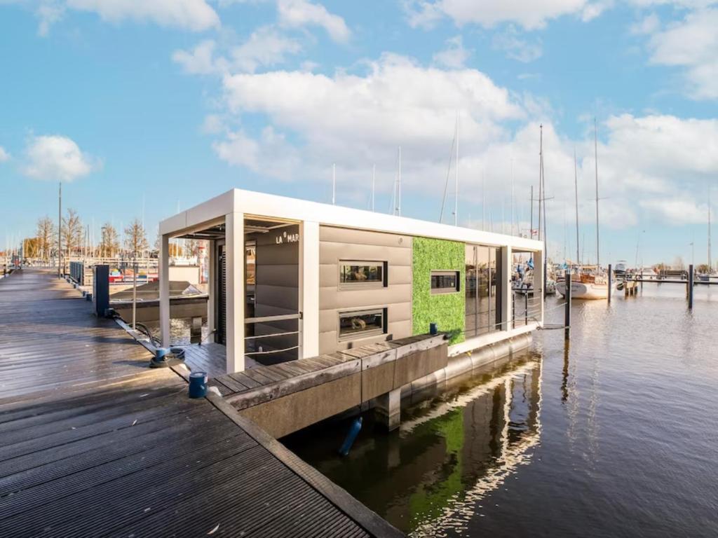 a building on a dock on a body of water at Marina Sunrise in Volendam