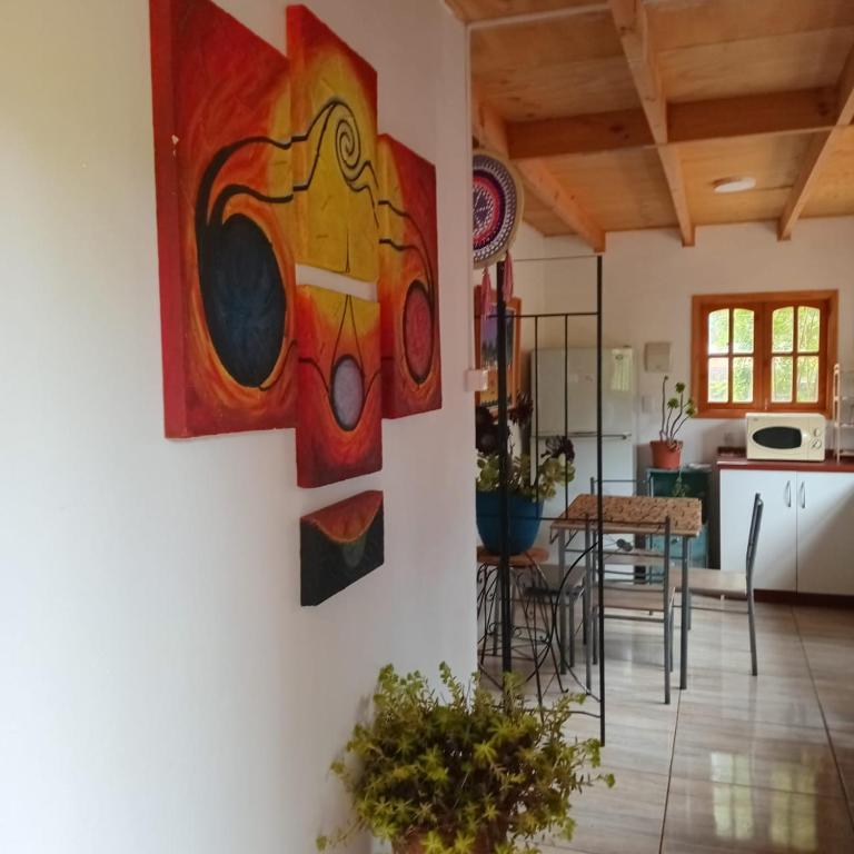 a living room with paintings on the wall at Mi Guarida in El Tabo