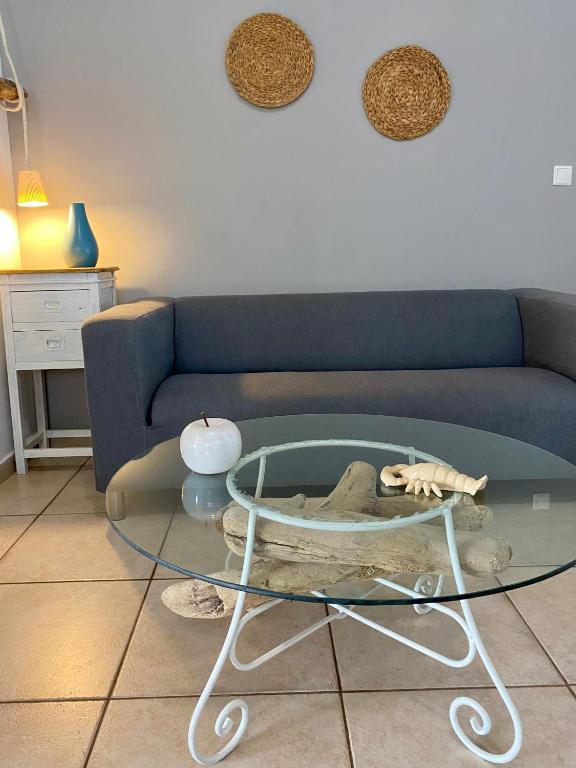a living room with a couch and a glass table at A & D Houses in Patra