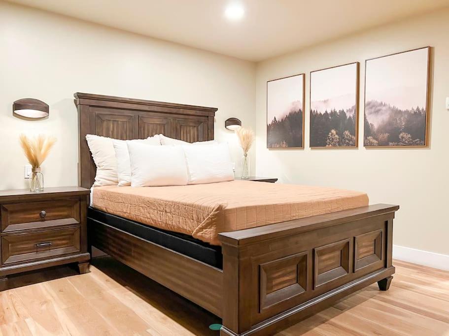 a bedroom with a large bed and two windows at Cozy Mountainside Den in Steamboat Springs