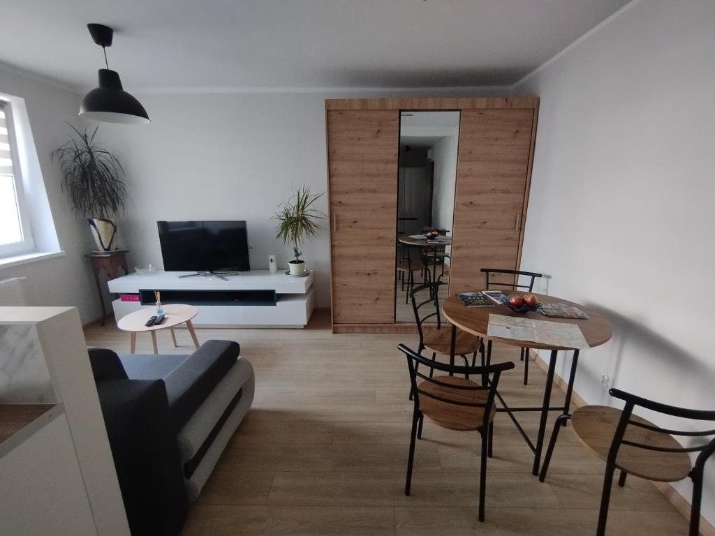 a living room with a couch and a table at Apartament Na Głucho in Nysa