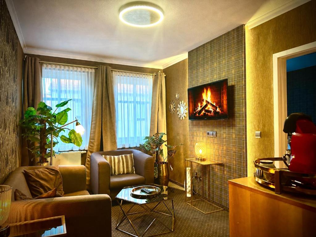a living room with a couch and a fireplace at Querfurter Hof in Querfurt