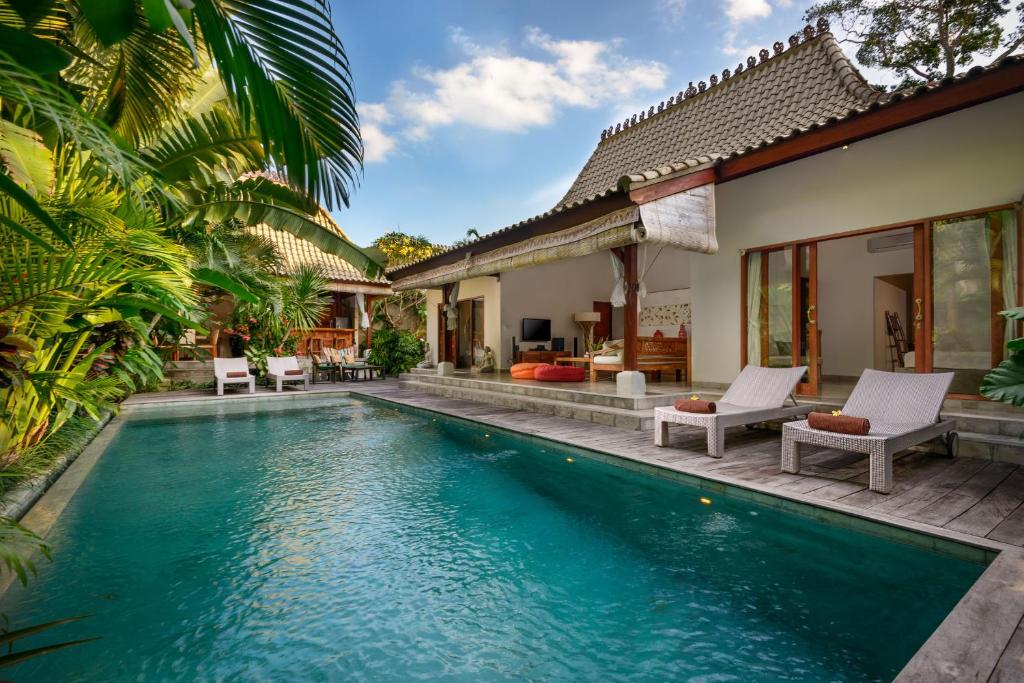 a pool in the backyard of a villa at Villa Vastu Seminyak in Seminyak
