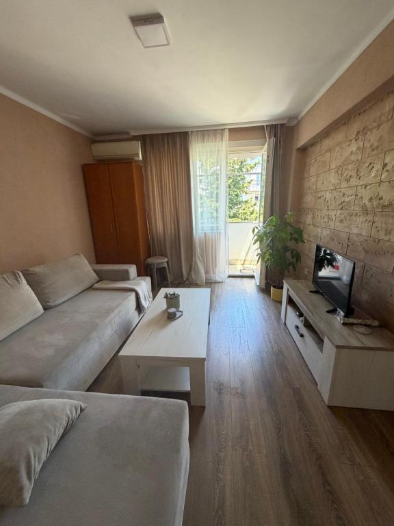 a living room with a couch and a tv at Bar City Apt in Bar