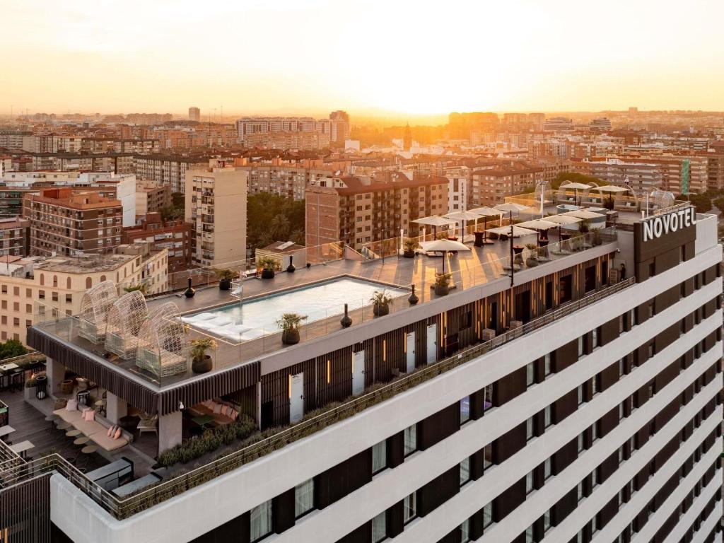an aerial view of a building with a pool on the roof at Novotel Valencia Lavant in Valencia