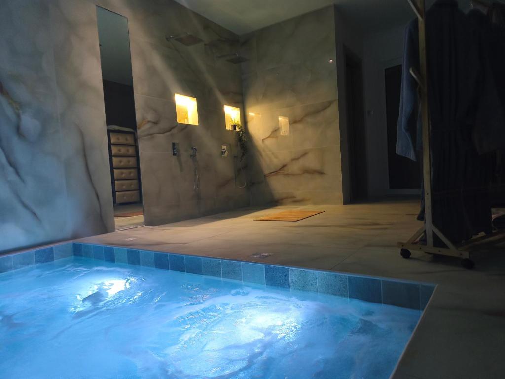 a bathroom with a large tub in a room at Aianteio Square Resort -SPA in Aiándion