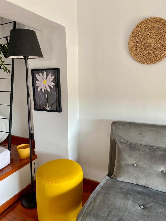 a yellow chair and a lamp in a room at A & D Houses No2 in Patra