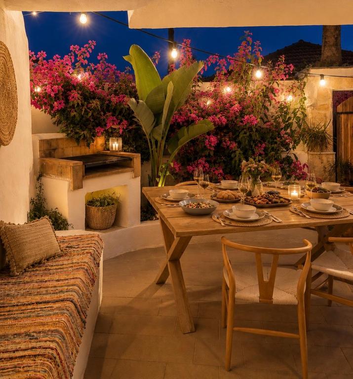 a table and chairs in a patio with flowers at Katoi traditional house in Éxo Khóra