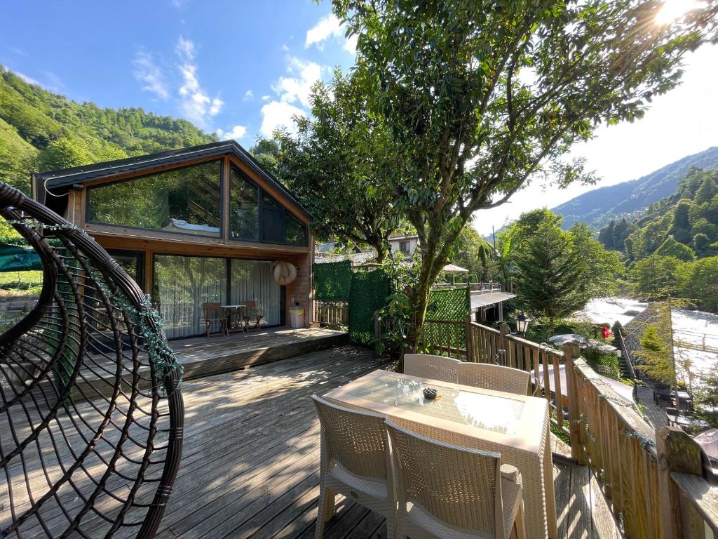 a house with a deck with a table and chairs at IVA House in Çamlıhemşin