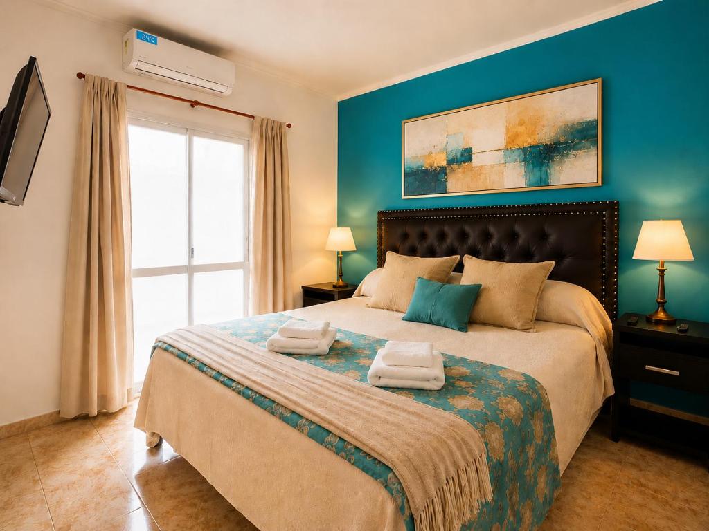 a bedroom with a large bed with towels on it at Apartamento Lo de Ana in Termas de Río Hondo