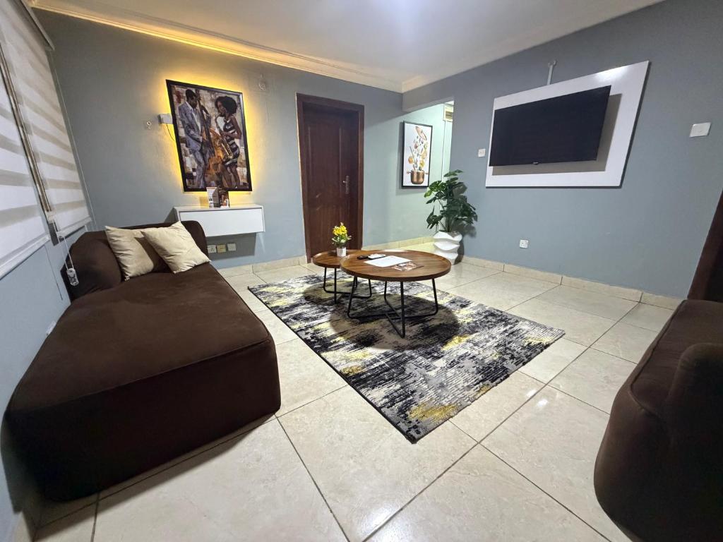 a living room with a couch and a table at Max Horizon in Ikeja