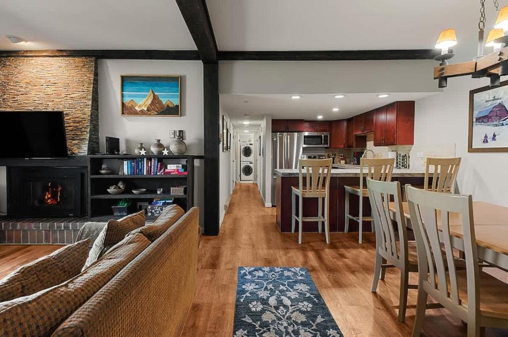 a kitchen and living room with a table and chairs at Rockies Alpine Haven in Steamboat Springs