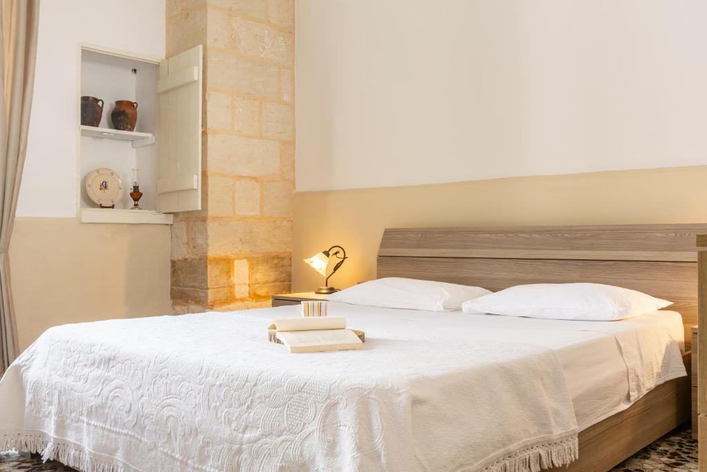 a bedroom with a large bed with a white bedspread at Rifugio del Sole in Cutrofiano