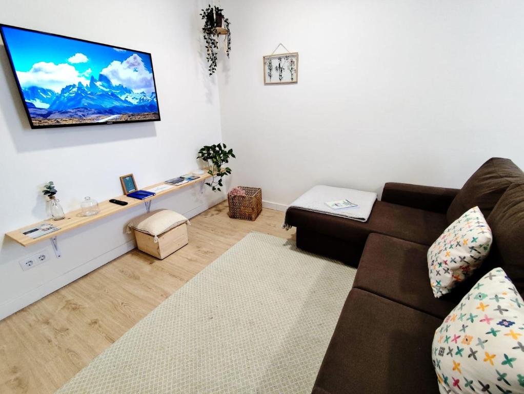 a living room with a couch and a flat screen tv at Airtegal A Capelada Cedeira in Cedeira