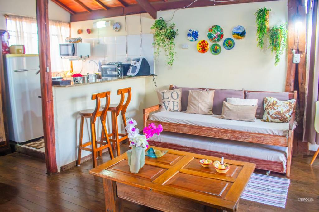 a living room with a couch and a table at CHALÉ ADOBE in Carrancas