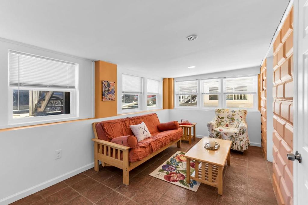 a living room with a couch and a table at 4BR Bungalow Steps to the Beach in Seaside Heights