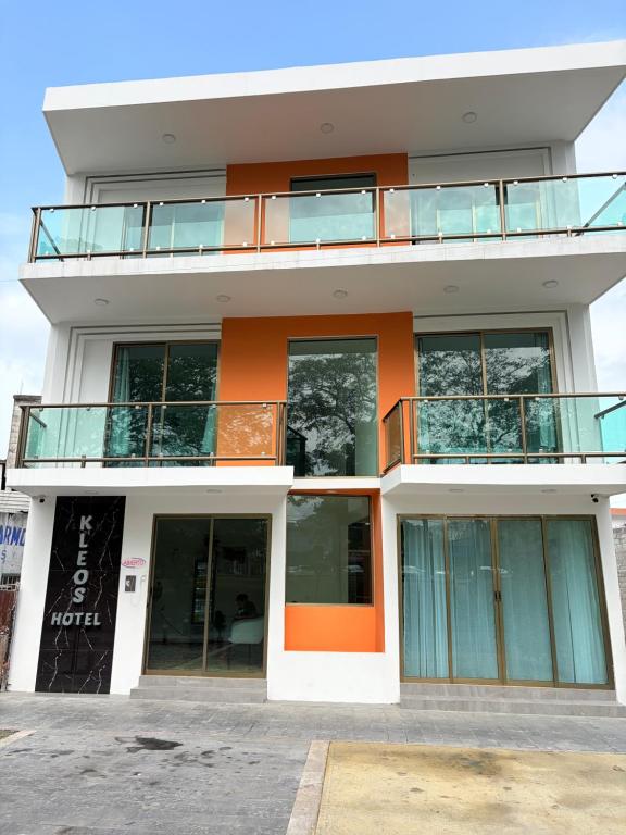 a building with an orange and white at Hotel Kleos in Cárdenas