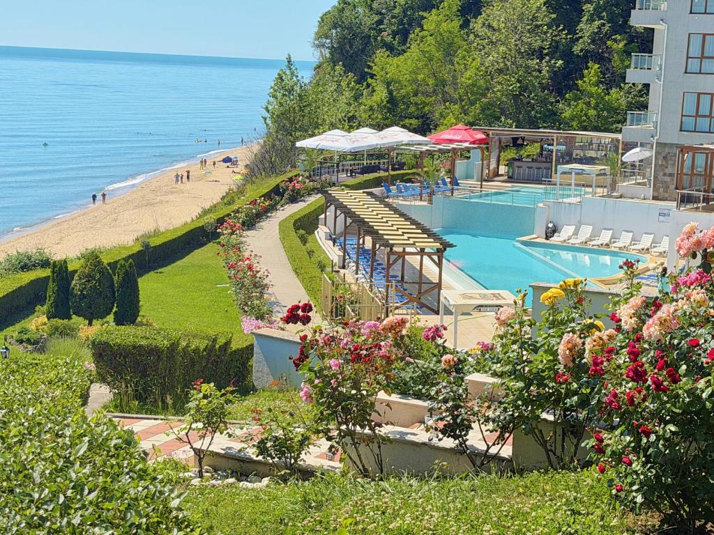 a resort with a swimming pool and a beach at Бяла Виста Клиф - Byala Vista Cliff in Byala